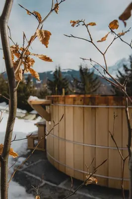 a wooden tub sitting on top of a snow covered slope at Chalet de Luxe 5 chambres Vue MontBlanc ,Spa, Jacuzzi, Salle de sport in Saint-Gervais-les-Bains