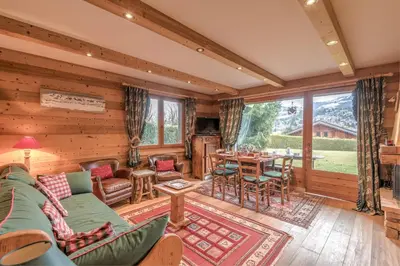 a living room with a couch and a table at Appartement Piton - Welkeys in Megève