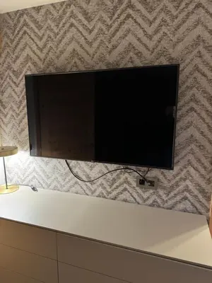 a flat screen tv hanging on a wall at Megeve les skis aux pieds in Megève
