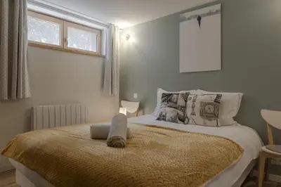 a bedroom with a bed with a money pillow on it at Pierre Belle - 80m2 - Grande Terrasse et Jardin in Chamonix-Mont-Blanc