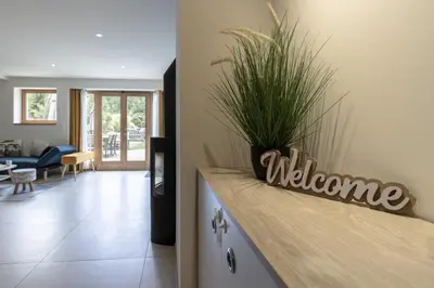 a living room with a welcome sign on a counter at Pierre Belle - 80m2 - Grande Terrasse et Jardin in Chamonix-Mont-Blanc