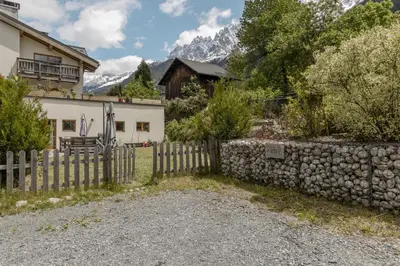 a fence in front of a house with a mountain at Pierre Belle - 80m2 - Grande Terrasse et Jardin in Chamonix-Mont-Blanc