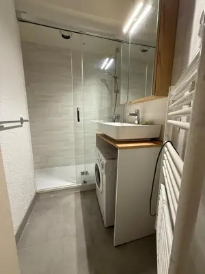 a bathroom with a sink and a washing machine at 2P Chamonix Aiguille du Midi in Chamonix-Mont-Blanc