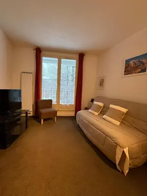 a bedroom with a large bed and a television at 2P Chamonix Aiguille du Midi in Chamonix-Mont-Blanc