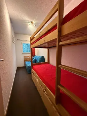 a small room with two bunk beds in it at 2P Chamonix Aiguille du Midi in Chamonix-Mont-Blanc