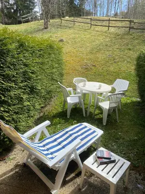 a group of chairs and a table and chairs at Studio Cosy 4 personnes avec jardin in Combloux