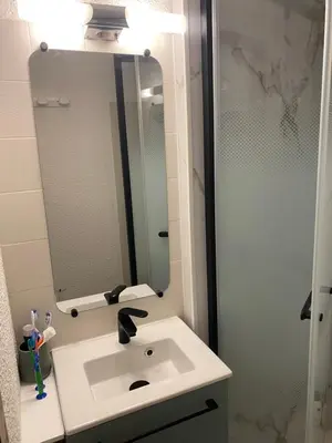 a bathroom with a sink and a mirror at Studio Cosy 4 personnes avec jardin in Combloux