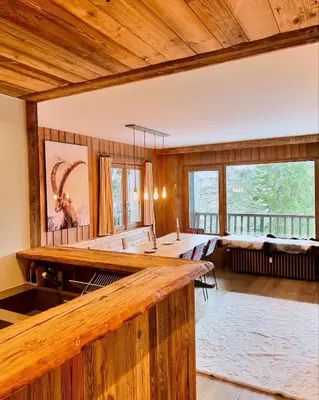 a large room with a bar in a log cabin at Fairway in Megève