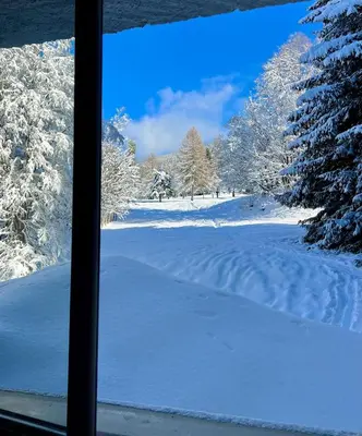 a view of a snow covered field from a window at Fairway in Megève