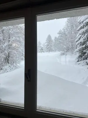 a view of a snow covered yard from a window at Fairway in Megève