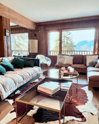 a living room with a couch and a table at Fairway in Megève