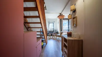 a kitchen with a staircase leading to a living room at Grand Horizon 1 N401 - 3P6 in Morillon