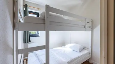 a white bunk bed in a room with a white bed at Grand Horizon 1 N401 - 3P6 in Morillon