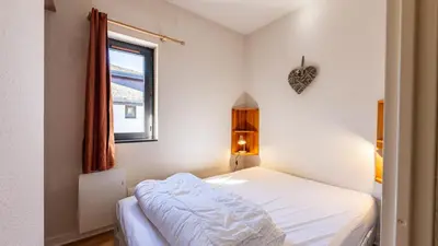 a small bedroom with a bed and a window at Grand Horizon 1 N401 - 3P6 in Morillon