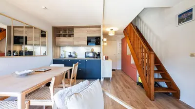 a kitchen and dining room with a table and a staircase at Grand Horizon 1 N401 - 3P6 in Morillon