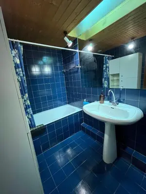 a blue tiled bathroom with a sink and a tub at Mont Blanc Panorama in Chamonix-Mont-Blanc
