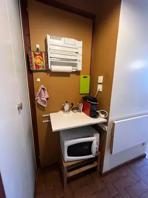 a small kitchen with a sink and a microwave at Mont Blanc Panorama in Chamonix-Mont-Blanc