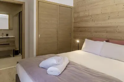 a bedroom with a bed with towels on it at Nid d'Aigle - Balcon avec vue Mont Blanc in Les Houches