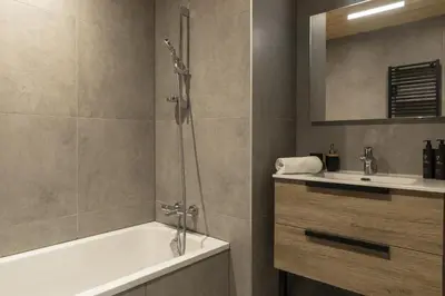a bathroom with a shower and a tub and a sink at Nid d'Aigle - Balcon avec vue Mont Blanc in Les Houches