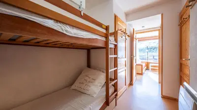 a bedroom with two bunk beds and a hallway at Les Eterlous N07 - 2P5 in Morillon