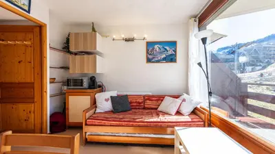 a living room with a couch and a window at Les Eterlous N07 - 2P5 in Morillon