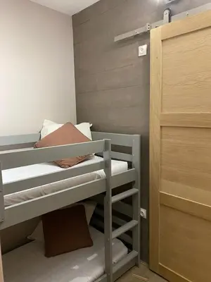 a small room with two bunk beds and a closet at Havre de paix à Flaine in Arâches-la-Frasse