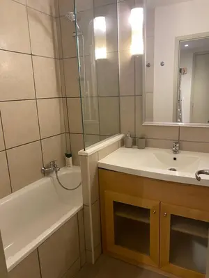 a bathroom with a tub and a sink and a shower at Havre de paix à Flaine in Arâches-la-Frasse