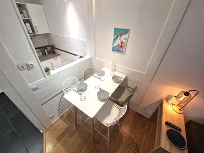 a white table with two chairs and a laptop on it at La Floria, Vue Mont Blanc in Chamonix-Mont-Blanc