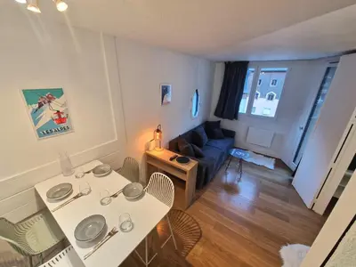 a small living room with a table and a couch at La Floria, Vue Mont Blanc in Chamonix-Mont-Blanc