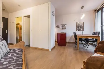 a living room with a couch and a table at Apartment Balme 3B - A Chamonix Mont Blanc Haven in Chamonix-Mont-Blanc