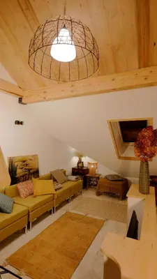 a living room with couches and a ceiling at L'ENVOLéE in Samoëns