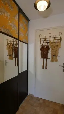 a hallway with baskets hanging on the wall at L'ENVOLéE in Samoëns