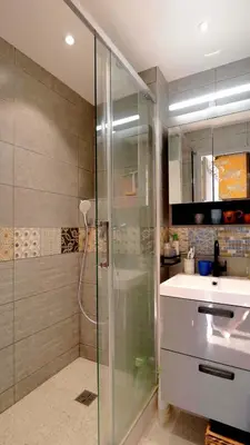 a bathroom with a glass shower and a sink at L'ENVOLéE in Samoëns
