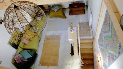 an overhead view of a living room with a staircase at L'ENVOLéE in Samoëns