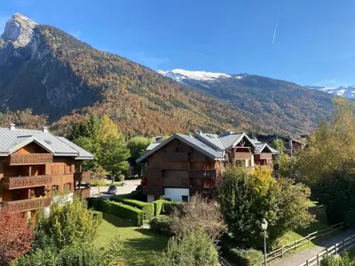 a group of houses in front of a mountain at L'ENVOLéE in Samoëns