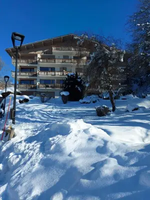 a building in the snow with a pile of snow at Elégance Alpine - Proche centre de Megève in Megève