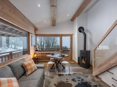 a living room with a couch and a table at Elégance Alpine - Proche centre de Megève in Megève