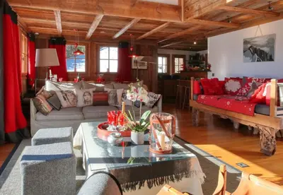 a living room with a couch and a table at Chalet Foret Rouge in Chamonix-Mont-Blanc
