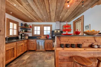 a kitchen with wooden cabinets and a wooden ceiling at Chalet Foret Rouge in Chamonix-Mont-Blanc