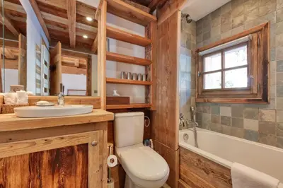 a bathroom with a toilet and a sink and a tub at Chalet Foret Rouge in Chamonix-Mont-Blanc