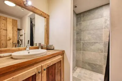 a bathroom with a sink and a shower at Chalet Foret Rouge in Chamonix-Mont-Blanc