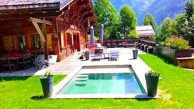 a house with a swimming pool in the yard at Chalet Foret Rouge in Chamonix-Mont-Blanc