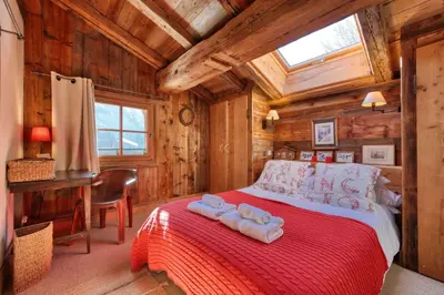 a bedroom with a bed with towels on it at Chalet Foret Rouge in Chamonix-Mont-Blanc