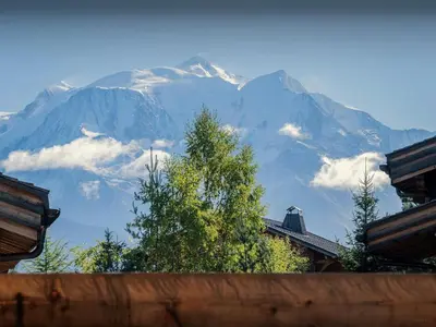 a view of a snow covered mountain from a house at Chalet Ellambra - OVO Network in Combloux