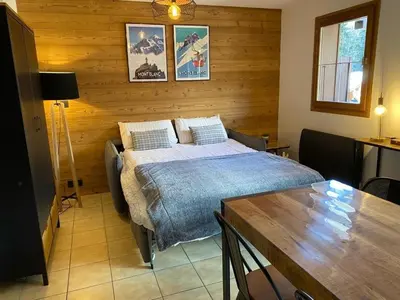 a bedroom with a bed and a table in it at Le Cocon des Cîmes in Les Contamines-Montjoie