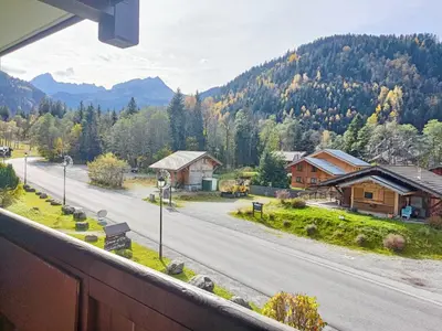 a view from a window of a road with mountains at Le Cocon des Cîmes in Les Contamines-Montjoie