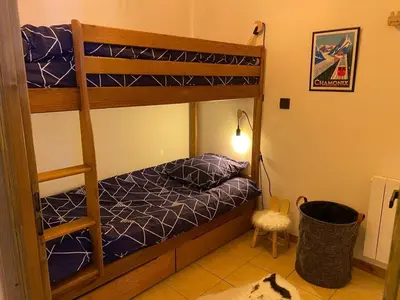 a bedroom with two bunk beds and a lamp at Le Cocon des Cîmes in Les Contamines-Montjoie