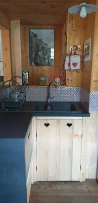 a kitchen with a sink and a counter top at Les Vardasses - Chalet typique avec jardin et vue sur les montagnes in Les Houches