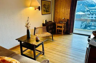 a living room with a couch and a table at Nice apartment with Mont Blanc balcony's view in Chamonix-Mont-Blanc