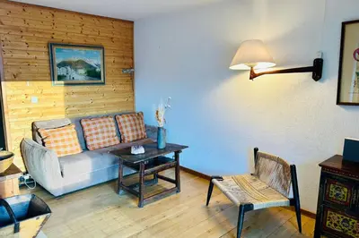 a living room with a couch and a table at Nice apartment with Mont Blanc balcony's view in Chamonix-Mont-Blanc